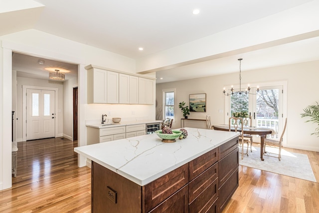 kitchen with plenty of natural light, light wood finished floors, and baseboards