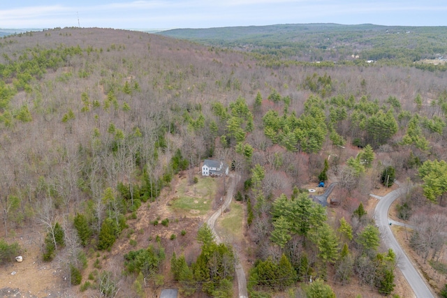 birds eye view of property with a wooded view