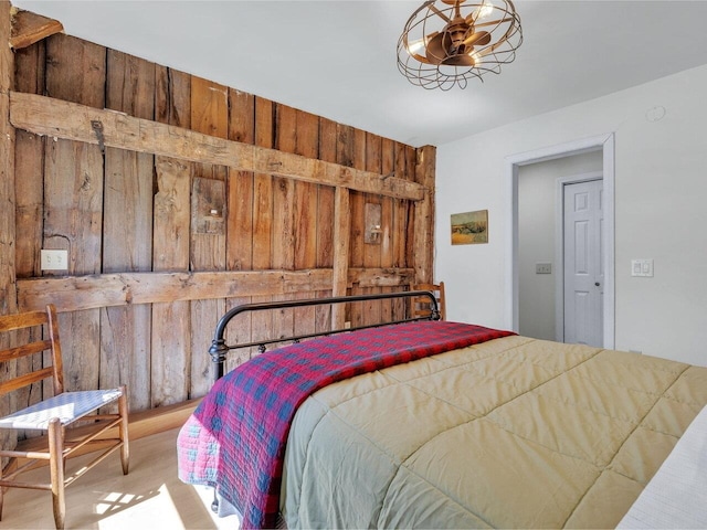bedroom with wood walls and wood finished floors