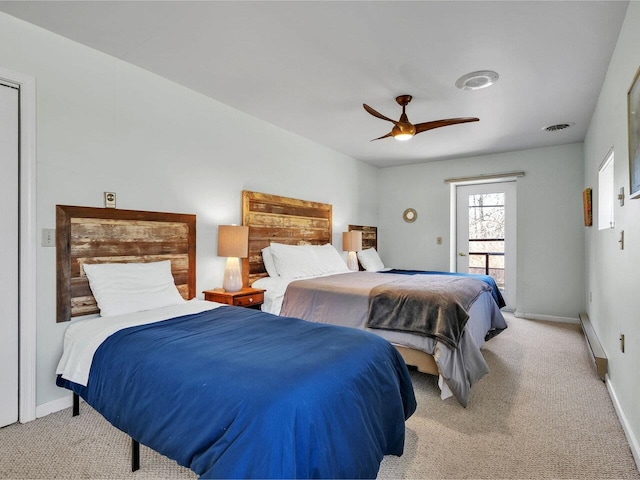 bedroom featuring a baseboard heating unit, baseboards, light colored carpet, and ceiling fan