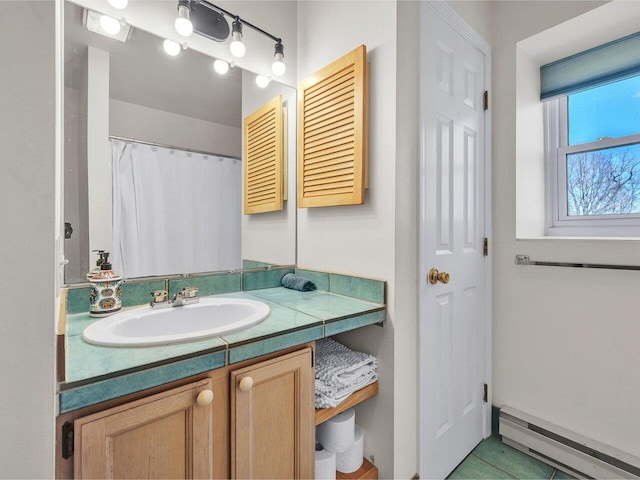 full bath with vanity and a baseboard radiator