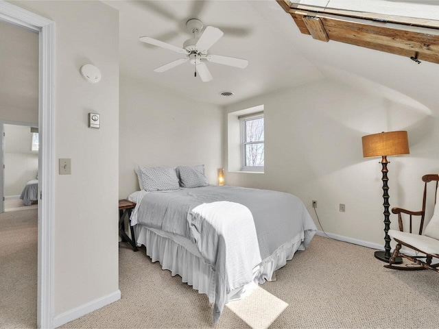 bedroom featuring lofted ceiling, light carpet, and baseboards