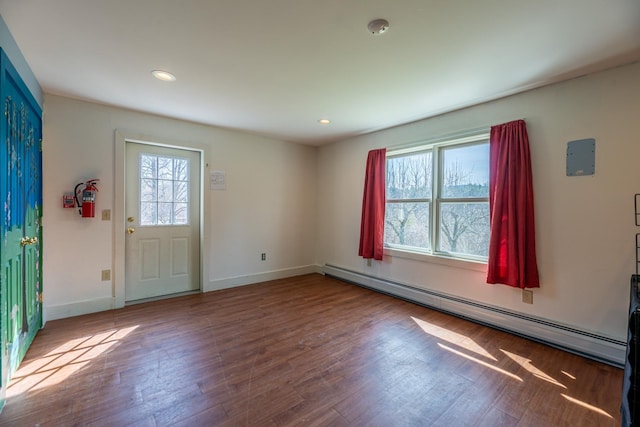 entryway with a baseboard radiator, baseboards, wood finished floors, and recessed lighting