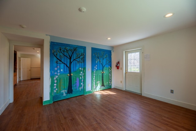 foyer with baseboards, wood finished floors, and recessed lighting