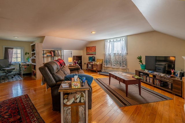 living room featuring hardwood / wood-style flooring, lofted ceiling, and recessed lighting