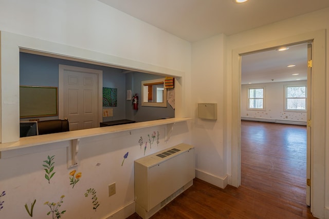 corridor featuring baseboards, recessed lighting, and dark wood-type flooring