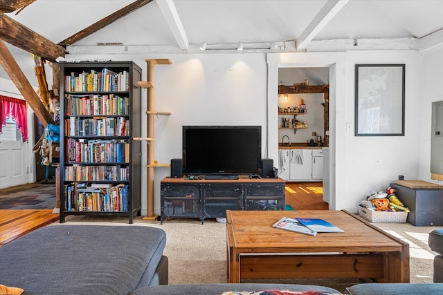 living room with vaulted ceiling with beams