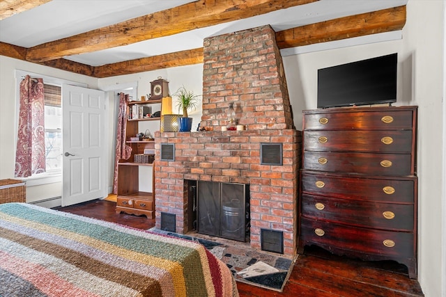 bedroom with wood-type flooring, a baseboard radiator, beamed ceiling, and a fireplace