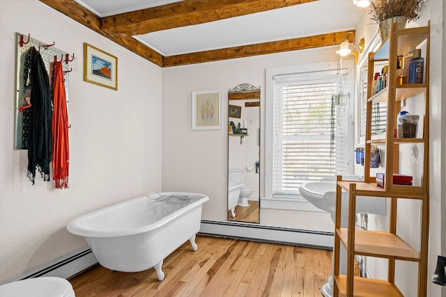 full bath with a baseboard radiator, toilet, and wood-type flooring