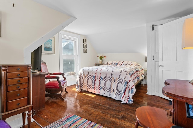bedroom featuring wood-type flooring and lofted ceiling
