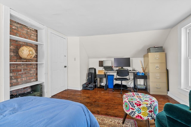 bedroom with lofted ceiling, baseboards, and wood finished floors