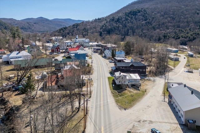 aerial view with a residential view, a view of trees, and a mountain view