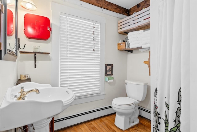 full bathroom with hardwood / wood-style flooring, a sink, a baseboard radiator, and toilet