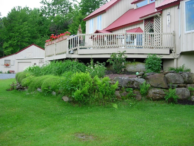 exterior space with an outbuilding, a deck, and a garage