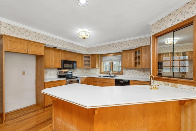11 Harvest Run, Gilford, NH 03249 - kitchen with glass insert cabinets, light wood-style flooring, brown cabinetry, black appliances, and a sink