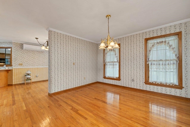 11 Harvest Run, Gilford, NH 03249 - unfurnished dining area with a chandelier, crown molding, an AC wall unit, wallpapered walls, and wood finished floors
