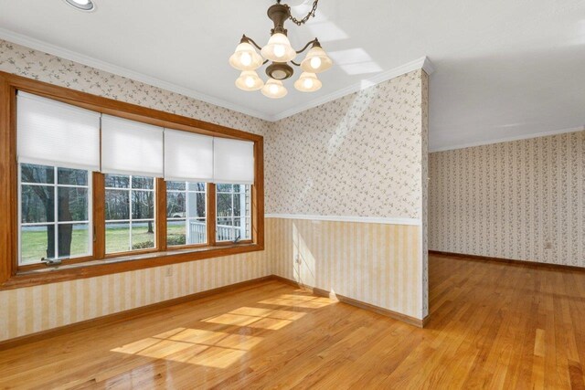 11 Harvest Run, Gilford, NH 03249 - unfurnished room featuring a notable chandelier, wallpapered walls, and hardwood / wood-style flooring