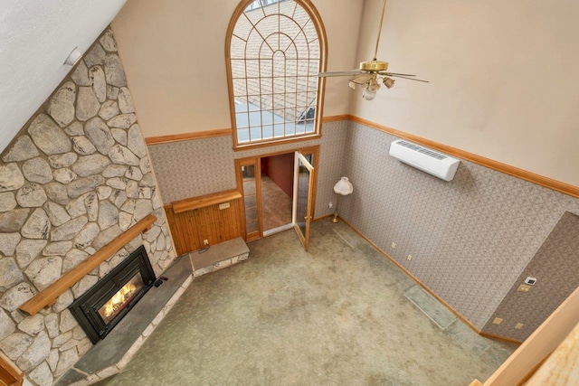 11 Harvest Run, Gilford, NH 03249 - interior space featuring a ceiling fan, a wainscoted wall, a stone fireplace, and a wall mounted AC