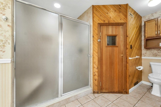 11 Harvest Run, Gilford, NH 03249 - bathroom featuring tile patterned floors, toilet, a stall shower, wainscoting, and wallpapered walls