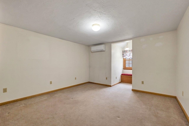 11 Harvest Run, Gilford, NH 03249 - unfurnished room featuring baseboards, a textured ceiling, light colored carpet, and a wall mounted AC