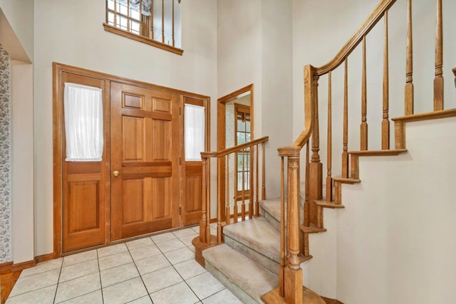11 Harvest Run, Gilford, NH 03249 - foyer featuring light tile patterned floors, stairs, and a high ceiling
