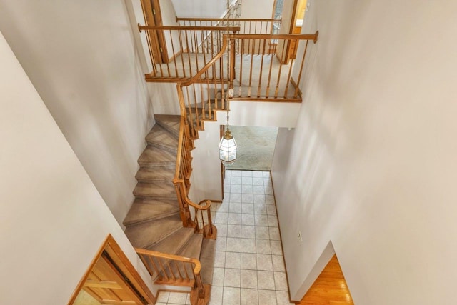 11 Harvest Run, Gilford, NH 03249 - stairway featuring tile patterned flooring and a high ceiling