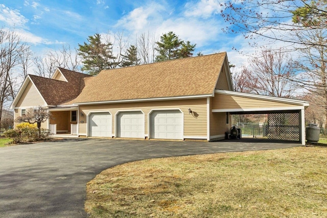11 Harvest Run, Gilford, NH 03249 - view of property exterior with a lawn, a shingled roof, an attached garage, and aphalt driveway