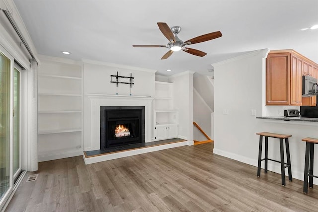 1 Dunvegan Woods Dr, Hampton, NH 03842 - unfurnished living room with ornamental molding, a ceiling fan, light wood finished floors, and recessed lighting