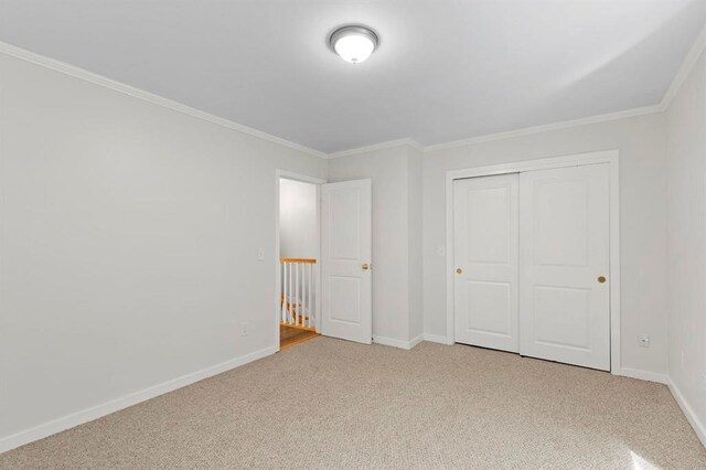 1 Dunvegan Woods Dr, Hampton, NH 03842 - unfurnished bedroom with a closet, light carpet, ornamental molding, and baseboards