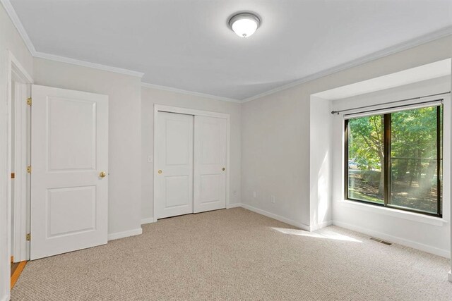 1 Dunvegan Woods Dr, Hampton, NH 03842 - unfurnished bedroom featuring light carpet, visible vents, baseboards, a closet, and ornamental molding
