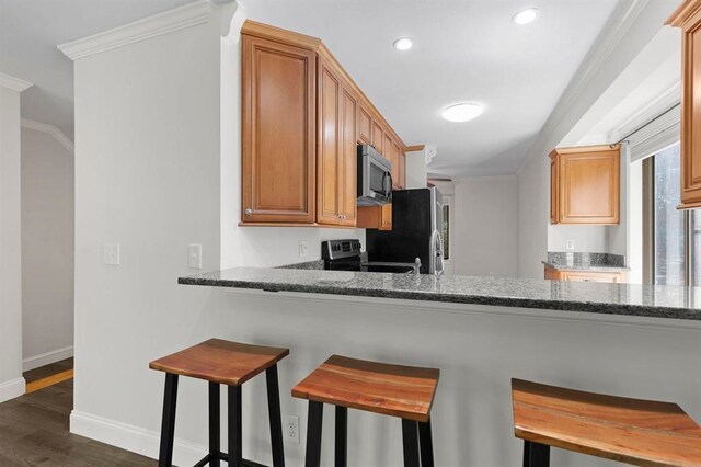 1 Dunvegan Woods Dr, Hampton, NH 03842 - kitchen featuring dark wood-type flooring, appliances with stainless steel finishes, baseboards, and ornamental molding