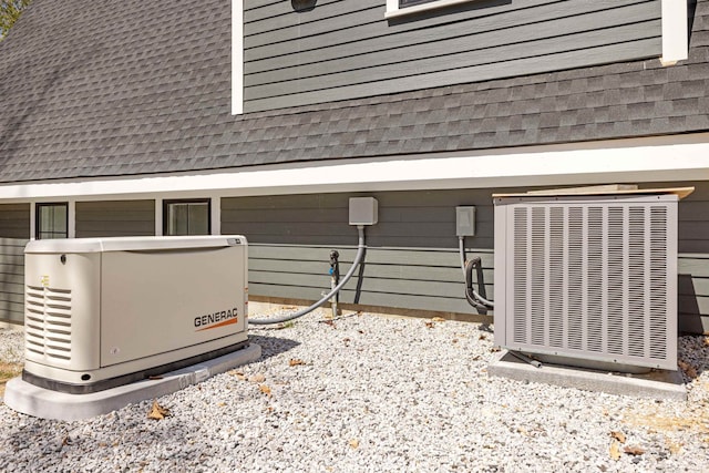 details with central AC, a power unit, and a shingled roof