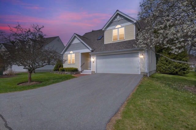 23 Hampton Mdws, Hampton, NH 03842 - traditional-style home featuring a front lawn, aphalt driveway, a shingled roof, and a garage