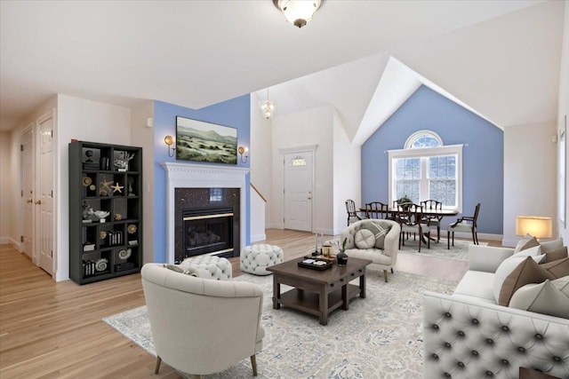 23 Hampton Mdws, Hampton, NH 03842 - living room with light wood-style floors, lofted ceiling, baseboards, and a high end fireplace