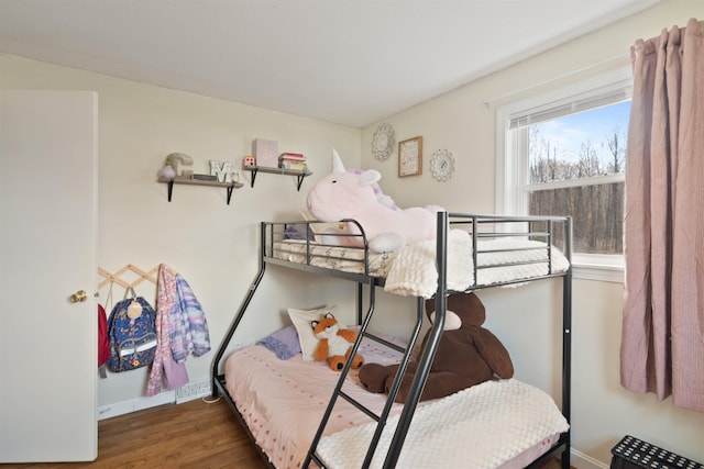 bedroom with baseboards and wood finished floors