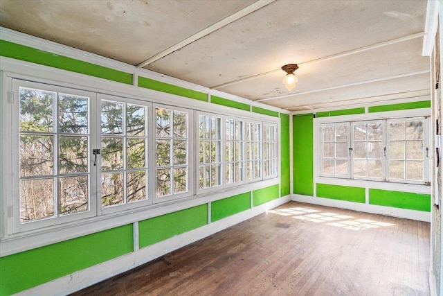 unfurnished sunroom with a healthy amount of sunlight and french doors