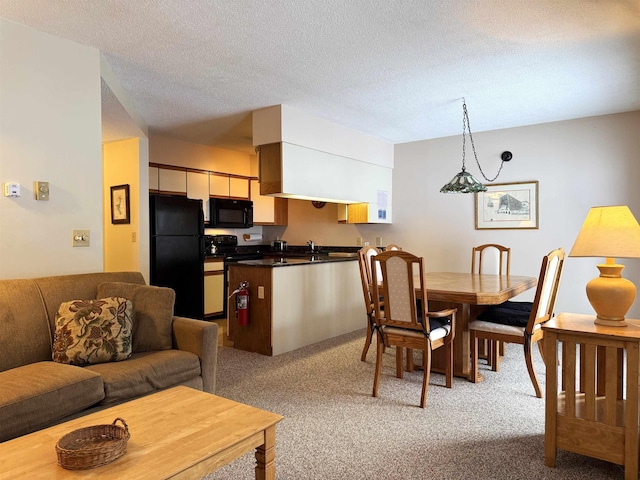 dining area with a textured ceiling and light carpet