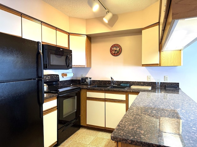 kitchen featuring a textured ceiling, a sink, white cabinetry, rail lighting, and black appliances