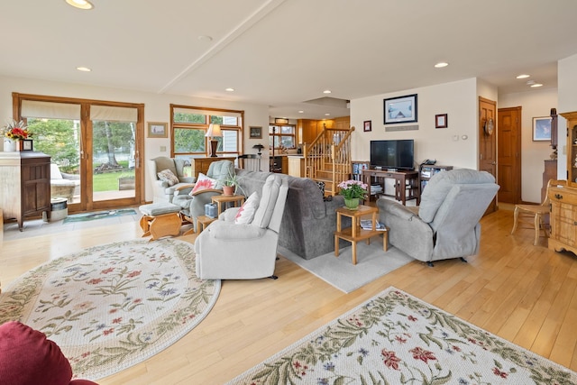 living area with wood finished floors, stairs, and recessed lighting