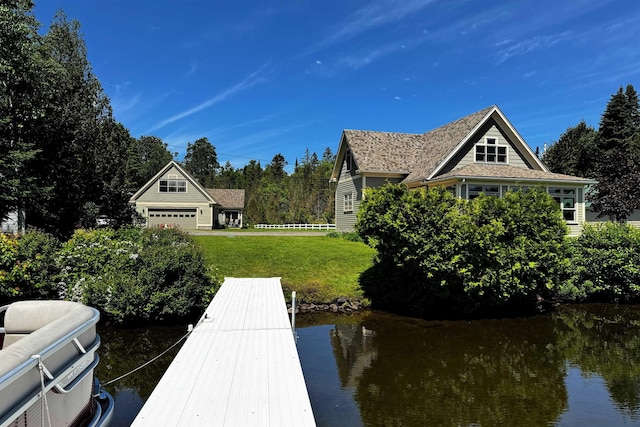 dock area featuring a water view and a yard