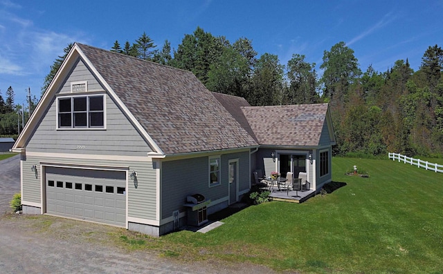 view of front facade featuring driveway, fence, a front yard, a garage, and a wooden deck