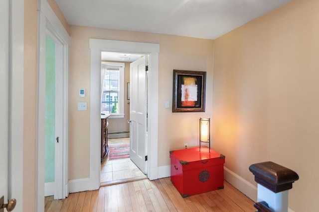 98 Hollis St, Manchester, NH 03101 - hallway with a baseboard heating unit, baseboards, and hardwood / wood-style floors