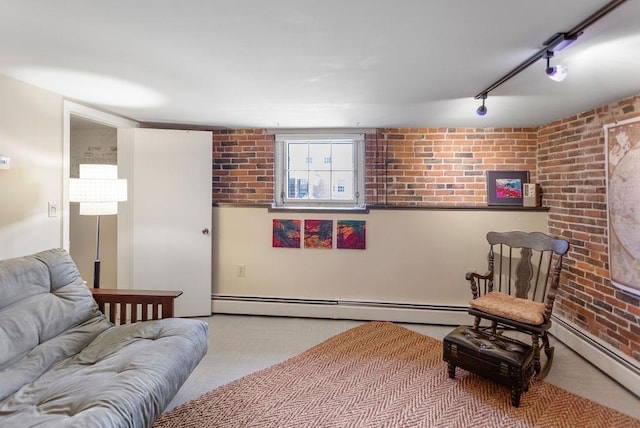 98 Hollis St, Manchester, NH 03101 - living room featuring a baseboard heating unit, brick wall, and rail lighting