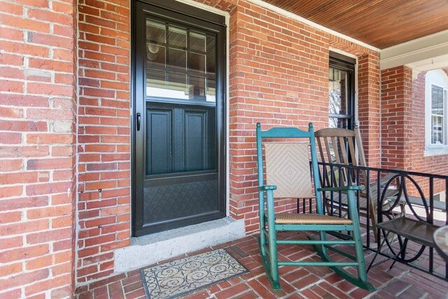 98 Hollis St, Manchester, NH 03101 - entrance to property with brick siding and covered porch
