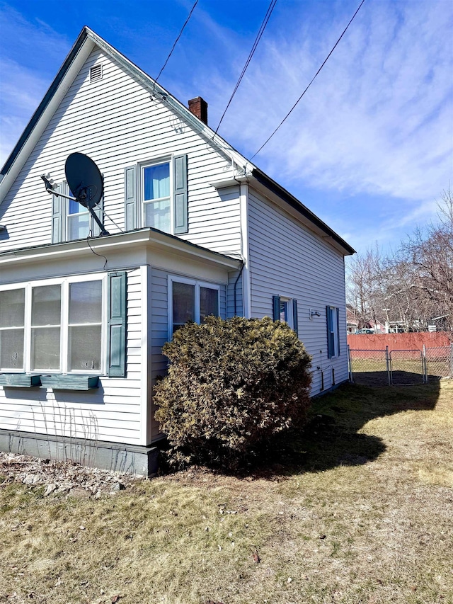 14 Summer St, Northumberland, NH 03582 - view of home's exterior with a chimney, fence, and a lawn