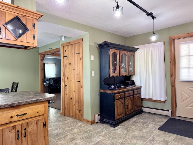 14 Summer St, Northumberland, NH 03582 - kitchen featuring a baseboard heating unit, baseboards, dark countertops, and light tile patterned floors