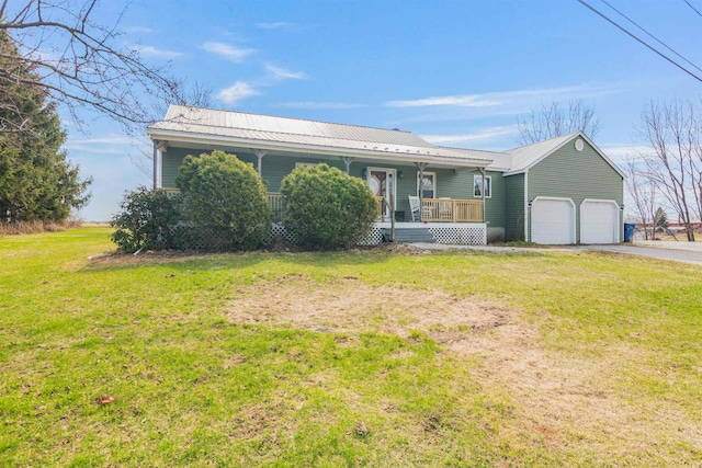 single story home with an attached garage, a front lawn, covered porch, and metal roof