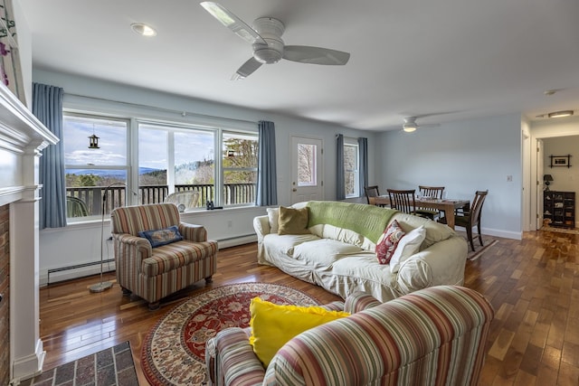 living room featuring a baseboard radiator, a ceiling fan, and hardwood / wood-style floors