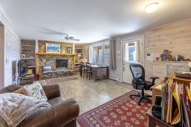 interior space featuring a ceiling fan, crown molding, wood finished floors, a stone fireplace, and wood walls