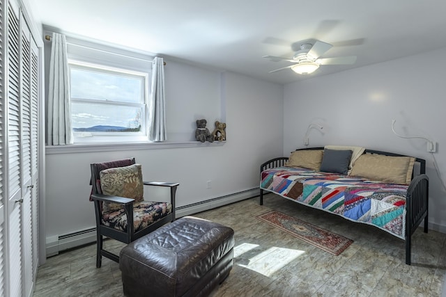 bedroom with a baseboard radiator, a ceiling fan, and a closet